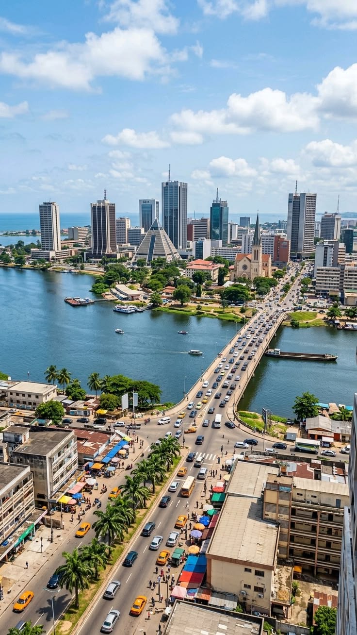 Aerial view of the Charles de Gaulle bridge and Abidjan's Plateau skyline over the lagoon
